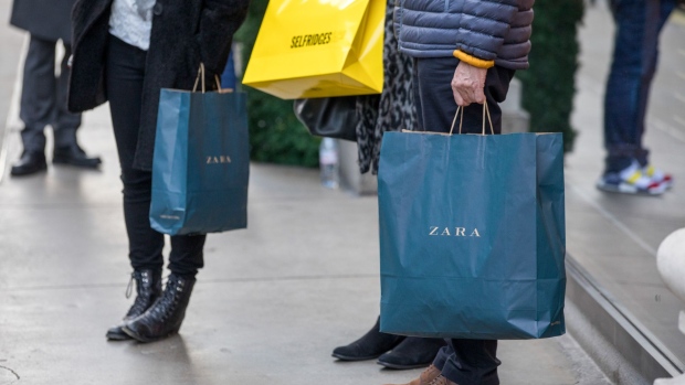 Shopper hold bags from Zara clothing retail shops, operated by Inditex SA, and Selfridges & Co. Ltd. department store in London, U.K. on Monday, Nov. 5, 2018. U.K. retail sales growth weakened in October after a summer of strong spending, according to the Confederation of British Industry. 