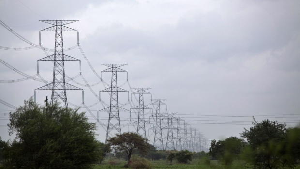 Electricity transmission towers stand in farm land in the Marathwada region of Maharashtra, India, on Friday, Aug. 17, 2018. Modi is seeking to spend more on the countryside -- home to about 68 percent of India's 1.3 billion people and a key voting bloc in the world's largest democracy -- as he prepares to face general elections in eight months. 