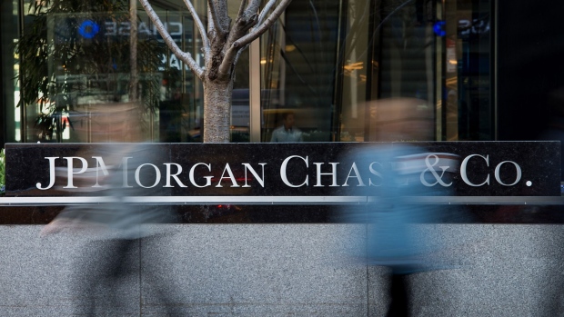 Pedestrians pass in front of the JPMorgan Chase & Co. headquarters building in New York, U.S., on Thursday, April 10, 2014. 
