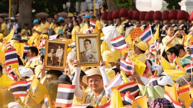 An attendee holds an image of Thai King Maha Vajiralongkorn ahead of his appearance on a balcony at the Grand Palace in Bangkok, Thailand, on May 6. 