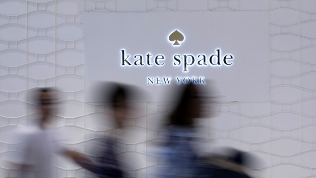 People walk past signage for a Kate Spade & Co. store at CentralWorld shopping mall, operated by Central Pattana Pcl (CPN), in Bangkok, Thailand, on Saturday, June 16, 2018.