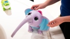An employee demonstrates a Spin Master Corp. Wildluvs brand Juno My Baby Elephant toy at a Toys "R" Us Inc. store in Paramus, New Jersey, U.S., on Tuesday, Nov. 26, 2019. The new store in the Garden State Plaza is the first of 10 locations planned to be operational by the end of next year. 