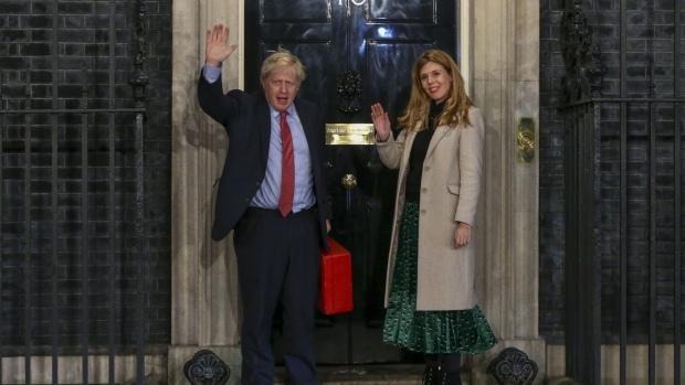 Johnson and his partner Carrie Symonds at Downing Street. Click here for Bloomberg’s most compelling political images from the past week. Photographer: Hollie Adams/Bloomberg