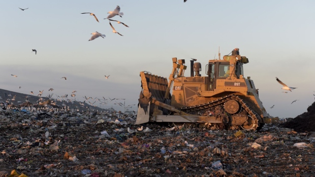 A bulldozer moves garbage in a landfill cell at the Melbourne Regional Landfill site, operated by at Cleanaway Waste Management Ltd., in Ravenhall, Victoria, Australia, on Wednesday, June 14, 2017. Cleanaway, the nation's largest garbage company, has the potential to extract enough gas from rotting rubbish to produce electricity for as many as 80,000 homes, according to Chief Executive Officer Vik Bansal. 