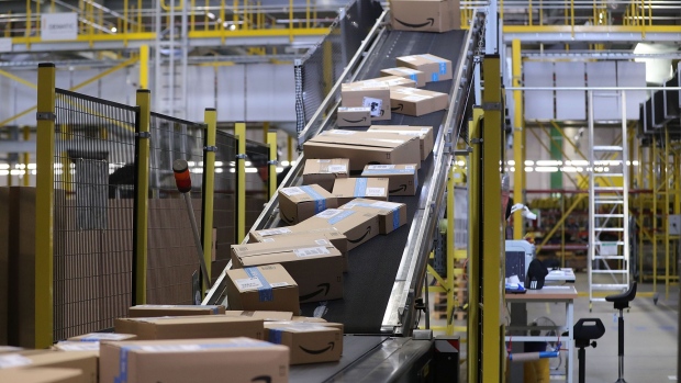 Sealed boxes move along a conveyor into a truck dock ahead of shipping from an Amazon.com Inc. fulfilment center during the online retailer's Prime Day sales promotion day in Koblenz, Germany, on Monday, July 15, 2019. Amazon is tapping high-profile actors, athletes and social-media sensations like never before to maintain buzz around its Prime Day summer sale, now in its fifth year and battling increasing competition from rivals. 