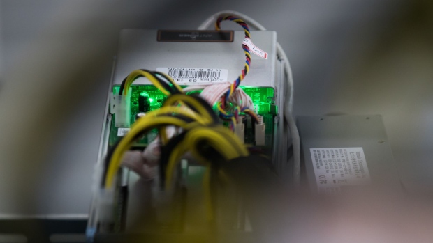 Cables are attached to an application-specific integrated circuit (ASIC) device and power unit, manufactured by Bitmain Technologies Inc., at a cryptocurrency mining facility in Incheon, South Korea, on Friday, Dec. 15, 2017. Hedge funds are pulling out of gold bets as more exciting moves in equities and cryptocurrencies make safe-haven investments look boring. 