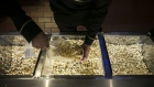 An employee scoops popcorn at a concessions stand at the Paragon Cineplex cinema.