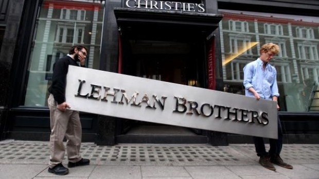 LONDON, ENGLAND - SEPTEMBER 24: Two employees of Christie's auction house manoeuvre the Lehman Brothers corporate logo, which is estimated to sell for 3000 GBP and is featured in the sale of art owned by the collapsed investment bank Lehman Brothers on September 24, 2010 in London, England. The "Lehman Brothers: Artwork and Ephemera" sale will take place on September 29, 2010, on the second anniversary of the firm's bankruptcy, and comprises of artworks which hung on the walls of Lehman Brothers' offices in Europe. (Photo by Oli Scarff/Getty Images)