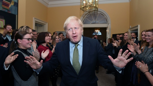 LONDON, ENGLAND - DECEMBER 13: Prime Minister Boris Johnson arrives back at 10 Downing Street after visiting Buckingham Palace where he was given permission to form the next government during an audience with Queen Elizabeth II on December 13, 2019 in London, England. The Conservative Party have realised a decisive win in the UK General Election. With one seat left to declare they have won 364 of the 650 seats available. Prime Minister Boris Johnson called the first UK winter election for nearly a century in an attempt to gain a working majority to break the parliamentary deadlock over Brexit. working majority to break the parliamentary deadlock over Brexit. He said at an early morning press conference that he would repay the trust of voters. (Photo by Stefan Rousseau - WPA Pool/Getty Images)
