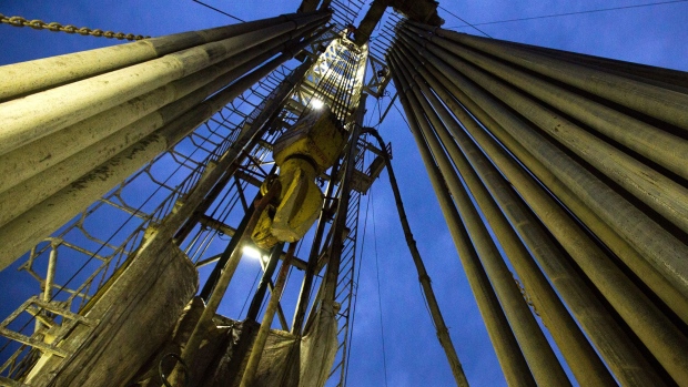 The travelling block hangs beside drill pipes on the derrick of a drill rig during oil drilling operations by Targin JSC, a unit of Sistema PJSFC, in an oilfield operated by Bashneft PAO near Ufa, Russia, on Thursday, Sept. 29, 2016. Bashneft distributes petroleum products and petrochemicals around the world and in Russia via filling stations. 