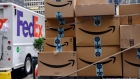 Amazon.com Inc. packages sit in front of a FedEx Corp. delivery truck in New York, U.S., on Monday, Nov. 26, 2018. Americans spent $50.6 billion online this month through Sunday, a 20 percent increase from a year ago and spearheaded by a 24 percent surge to $6.2 billion on Black Friday, according to Adobe Analytics. Cyber Monday is expected to add another $7.8 billion -- an 18 percent year-over-year gain for that day. 