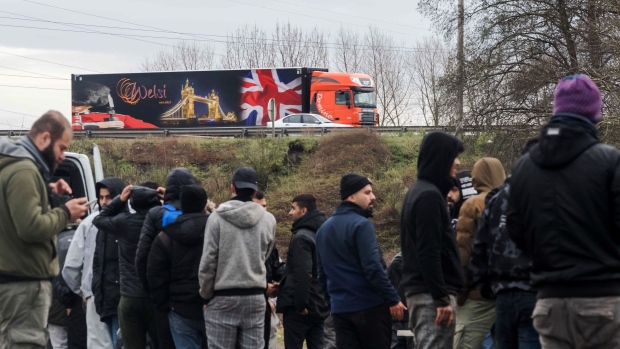 Kurdish-speaking migrants line up for food in Dunkirk, on Dec. 19. Photographer: Geert Vanden Wijngaert/Bloomberg