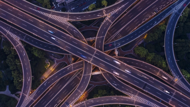 Vehicles travel along highways at dawn in this aerial photograph taken in Shanghai, China, on Sunday, Aug. 18, 2019. U.S. President Donald Trump said he plans for 10% tariffs on an additional $300 billion in Chinese imports, after an earlier imposed tariffs on $200 billion in Chinese imports. 