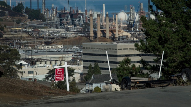 A "For Sale" sign is displayed near the Chevron Corp. Richmond Refinery in Richmond, California, U.S