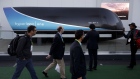 Attendees walk past a Virgin Hyperloop One XP-1 pod outside at the 2018 Consumer Electronics Show in Las Vegas. Photographer: Patrick T. Fallon/Bloomberg