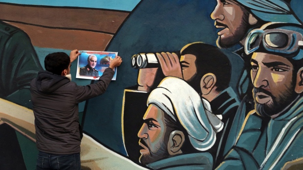TEHRAN, IRAN - JANUARY 03: A supporters mounts a photograph in memory of Qasem Souleimani after the U.S. airstrike in Iraq that killed the Iranian Revolutionary Guard General on January 3, 2020 in Tehran, Iran. Iran has vowed 'harsh retaliation' for the U.S. airstrike near Baghdad's airport that killed Tehran's top general as tensions soared in the wake of the targeted killing. (Photo by Majid Saeedi/Getty Images)