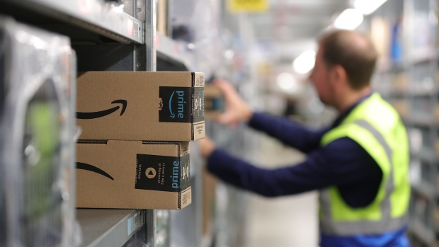 An order picker collects customer delivery orders at an Amazon.com Inc. fulfilment center during the online retailer's Prime Day sales promotion day in Koblenz, Germany, on Monday, July 15, 2019