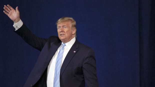 Donald Trump waves during an 'Evangelicals for Trump' Coalition launch event in Miami. 
