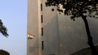 An Indian national flag flies at the Reserve Bank of India (RBI) building in Mumbai, India, on Wednesday, Oct. 16, 2019. Indian banks became the latest whipping boy for the slowdown in Asia’s third-largest economy that’s seen blame previously assigned to millennials and used cars. 