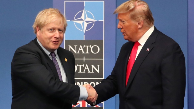 HERTFORD, ENGLAND - DECEMBER 04: British Prime Minister Boris Johnson shakes hands with US President Donald Trump onstage during the annual NATO heads of government summit on December 4, 2019 in Watford, England. France and the UK signed the Treaty of Dunkirk in 1947 in the aftermath of WW2 cementing a mutual alliance in the event of an attack by Germany or the Soviet Union. The Benelux countries joined the Treaty and in April 1949 expanded further to include North America and Canada followed by Portugal, Italy, Norway, Denmark and Iceland. This new military alliance became the North Atlantic Treaty Organisation (NATO). The organisation grew with Greece and Turkey becoming members and a re-armed West Germany was permitted in 1955. This encouraged the creation of the Soviet-led Warsaw Pact delineating the two sides of the Cold War. This year marks the 70th anniversary of NATO. (Photo by Steve Parsons-WPA Pool/Getty Images)