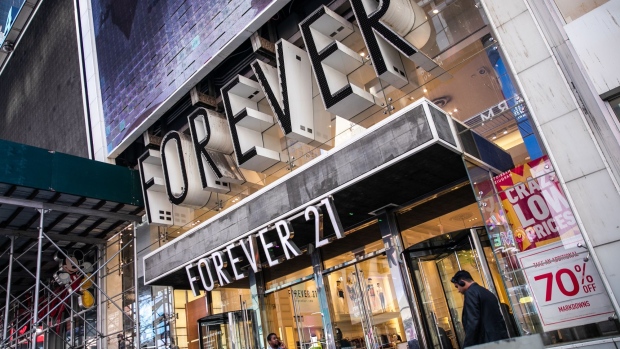 Pedestrians pass in front of a Forever 21 Inc. store in the Times Square neighborhood of New York, U.S., on Thursday, Aug. 29, 2019.
