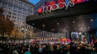 Shoppers wait outside the Macy's Inc. flagship store in New York, U.S., on Thursday, Nov. 28, 2019. A gauge of buying conditions in the U.S. advanced last week to 55.3, the highest ever leading up to the first shopping day after the Thanksgiving holiday, according to Bloomberg Consumer Comfort Index data. Photographer: Jeenah Moon/Bloomberg