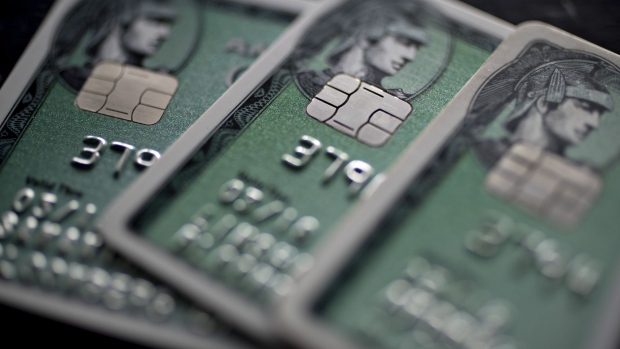 American Express Co. chip credit cards are arranged for a photograph in Washington, D.C., U.S., on Monday, Oct. 24, 2016. American Express surged the most in more than seven years after posting third-quarter profit that beat analysts' estimates and raising its full-year profit forecast. 