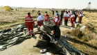 Rescue workers recover the bodies of victims of the wreckage of a Boeing Co. 737-800 aircraft