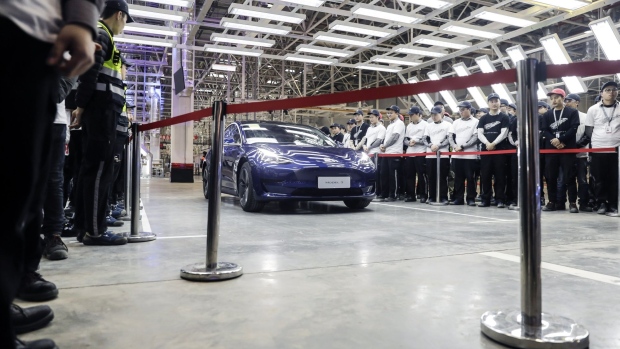 A Tesla Inc. Model 3 vehicle set to be delivered to a company employee moves off an assembly line during a ceremony at the company's Gigafactory in Shanghai, China, on Monday, Dec. 30, 2019. 