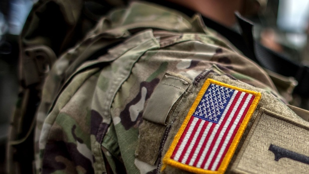 PRAGUE, CZECH REPUBLIC - MAY 27: A badge with flag of USA is placed on the sleeve of an U.S. soldier of the 2nd Cavalry Regiment of the US Army as he arrived with others at Czech army barracks on May 27, 2016 in Prague, Czech Republic. About 420 U.S. soldiers with 225 army vehicles are travelling in the 'Dragoon Ride II' convoy from Germany to Estonia where they will participate in the Saber Strike 16 exercise in the Baltic region. With this exercise, NATO shows cohesiveness and readiness of the involved countries to collective defense and future operations in Europe. (Photo by Matej Divizna/Getty Images) Photographer: Matej Divizna/Getty Images Europe