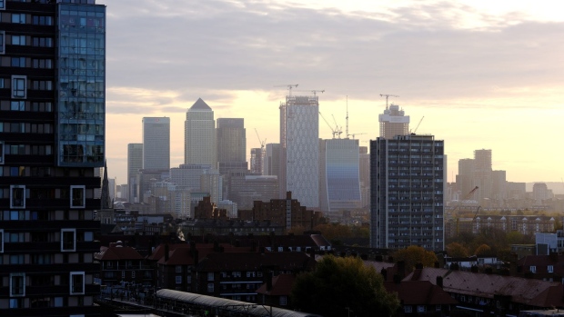 Skyscrapers in the Canary Wharf business, financial and shopping district, centre, including One Canada Square dominate the skyline above residential buildings in London, U.K., on Wednesday, Nov. 14, 2018. The City of London averted one disaster with the draft Brexit deal announced Wednesday, but the bottom line is that banks, brokers and asset managers will continue to prepare for the talks going off the rails. Photographer: Bryn Colton/Bloomberg