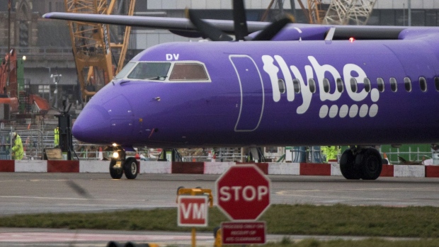 A passenger aircraft, operated by Flybe Group Plc, taxis along the tarmac at London City Airport in London. Photographer: Chris Ratcliffe/Bloomberg