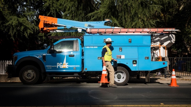 A PG&E Corp. troubleman first responder moves a safety cone in Calistoga, California, U.S., on Thursday, Oct. 24, 2019. In a deliberate blackout designed to keep power lines from igniting wildfires, PG&E and other utilities have cut service to nearly 200,000 homes and business in shutoffs that could eventually affect 1.5 million people as wind storms threaten to knock down power lines. Photographer: David Paul Morris/Bloomberg