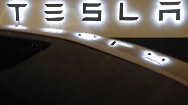 A Tesla logo is displayed on a Tesla Inc. Model S electric vehicle at a Supercharger station in Kriegstetten, Switzerland, on Thursday, Aug. 16, 2018. Tesla chief executive officer Elon Musk has captivated the financial world by blurting out via Twitter his vision of transforming Tesla into a private company. Photographer: Stefan Wermuth/Bloomberg