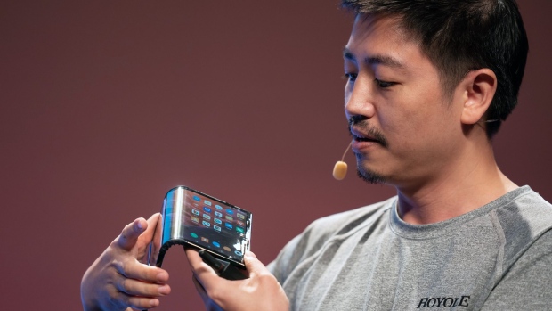 Bill Liu holds a Royole Corp. Flexpai smartphone in 2019. Photographer: Anthony Kwan/Bloomberg