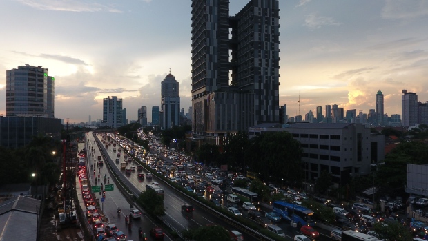 Vehicles travel along a road at dusk in Jakarta, Indonesia, on Thursday, Jan. 31, 2019. Indonesia is scheduled to release fourth-quarter gross domestic product (GDP) figures on Feb. 6. Photographer: Dimas Ardian/Bloomberg