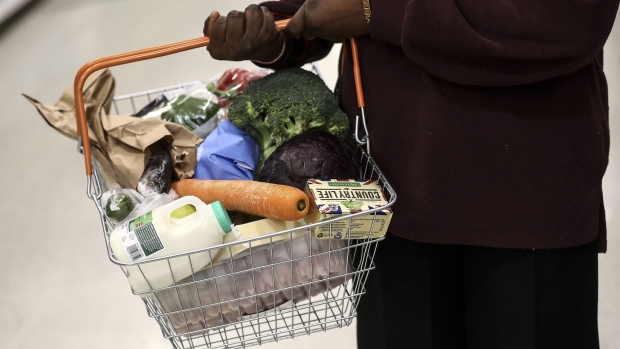 A shopper holds a basket of groceries inside a J Sainsbury Plc supermarket in Redhill, U.K., on Tuesday, March 27, 2018. Mike Coupe, J Sainsbury chief executive officer, spoke of the importance of having a strong online presence and improving efficiency to compete with Amazon. Photographer: Simon Dawson/Bloomberg