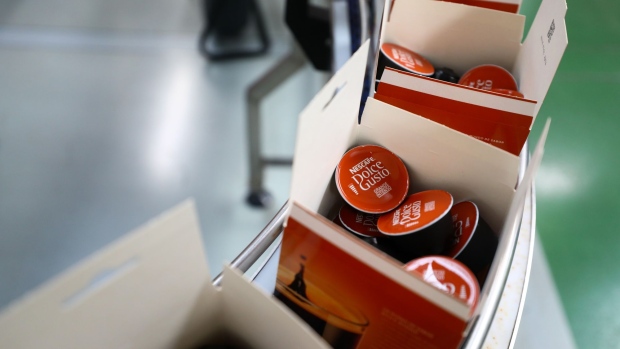 Boxes of the Nescafe Dolce Gusto Grande Intenso coffee pods travel along the production line at the Nescafe factory, operated by Nestle SA, in Tutbury, U.K., on Thursday, Aug. 23, 2018. European consumer-goods giants ranging from Nestle SA to Anheuser-Busch InBev NV and Diageo Plc are stepping up their response to activist threats by cutting costs, shedding underperforming brands and returning cash to investors. Photographer: Simon Dawson/Bloomberg