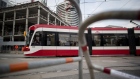 A Toronto Transit Commission (TTC) streetcar travels down a track in Toronto, Ontario