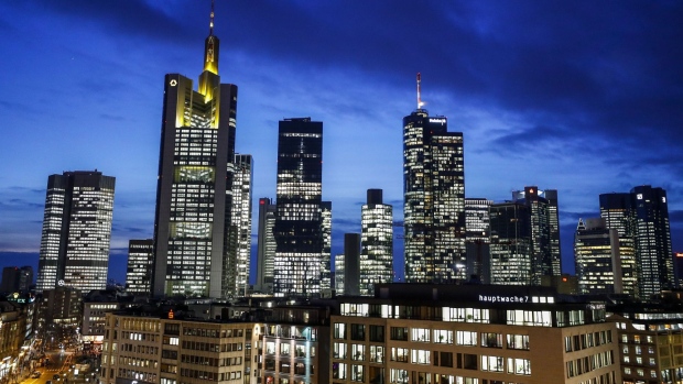 The Commerzbank AG headquarters, second left, and the Deutsche Bank AG twin towers, right, stand illuminated with other skyscrapers in the financial district in Frankfurt, Germany, on Monday, Jan. 13, 2020. Germany’s economy probably grew at the weakest pace since 2013 last year as carmakers to machinery makers were hit by trade tensions and the U.K.’s impending exit from the European Union, a report is expected to show Wednesday. Photographer: Alex Kraus/Bloomberg