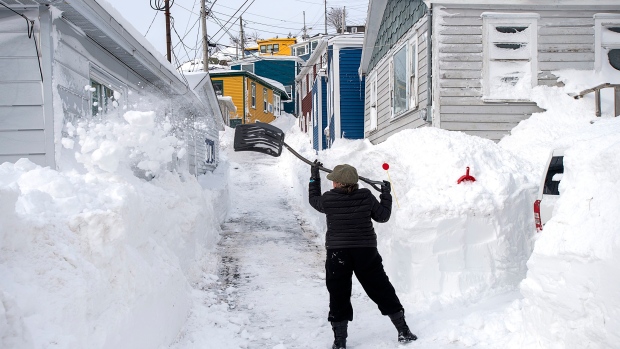 A resident clears snow in St. John’s on Sunday, Jan. 19, 2020. 