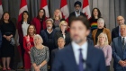Members of the federal Liberal cabinet listen as Prime Minister Justin Trudeau answers questions fro