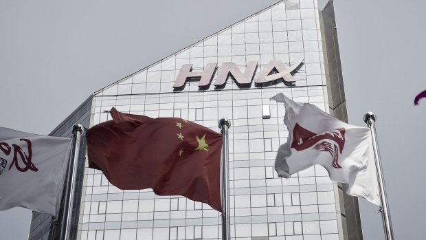 The HNAÂ Group Co. building stands in Beijing, China, on Wednesday, Aug. 9, 2017. Big Chinese dealmakers includingÂ HNAÂ have been under increasing scrutiny this year as the Communist Party steps up its clampdown of capital outflows to protect the yuan from weakening further. Photographer: Qilai Shen/Bloomberg
