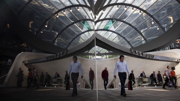 Commuters are reflected in a surface as they exit Wynyard Station in Sydney, Australia, on Monday, Nov. 11, 2019. Australia is bracing for more devastating bushfires, with swaths of the eastern seaboard and even areas of greater Sydney facing a "catastrophic" threat that's unprecedented at this time of year. Photographer: Brent Lewin/Bloomberg