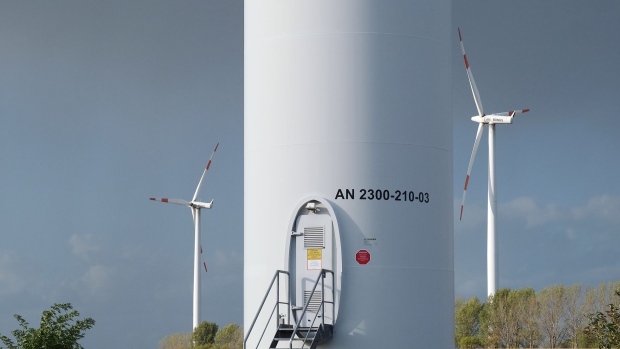 BORNSTEDT, GERMANY - SEPTEMBER 18: The entrance to the mast of a wind turbine stands near other wind turbines spinning at a wind farm on September 18, 2019 near Bornstedt, Germany.