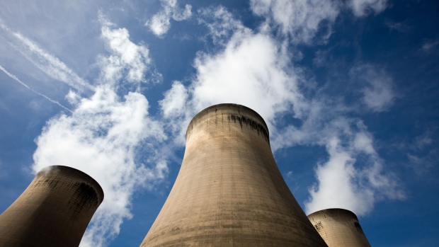 Cooling towers stand within the Drax Group Plc.'s power station complex near Selby, U.K. Photographer: Simon Dawson/ 