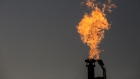 A gas flare burns at dusk in the Permian Basin in Texas, U.S. Photographer: Bloomberg