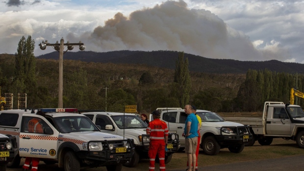 Firefighters extinguish a fire on a property in Moruya on Jan. 23. Photographer: Sam Mooy/Getty Images AsiaPac
