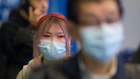 Passengers wear masks as they arrive at the international arrivals area at the Vancouver Internation