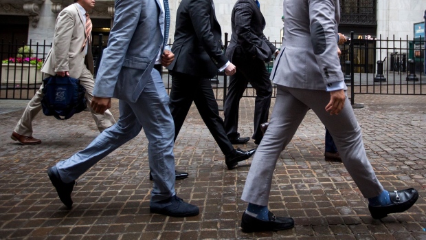 Pedestrians pass in front of the New York Stock Exchange. Photographer: Michael Nagle/Bloomberg